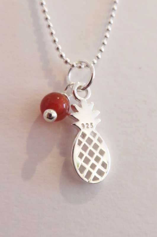 Silver pendant with pineapple charm and orange stone
